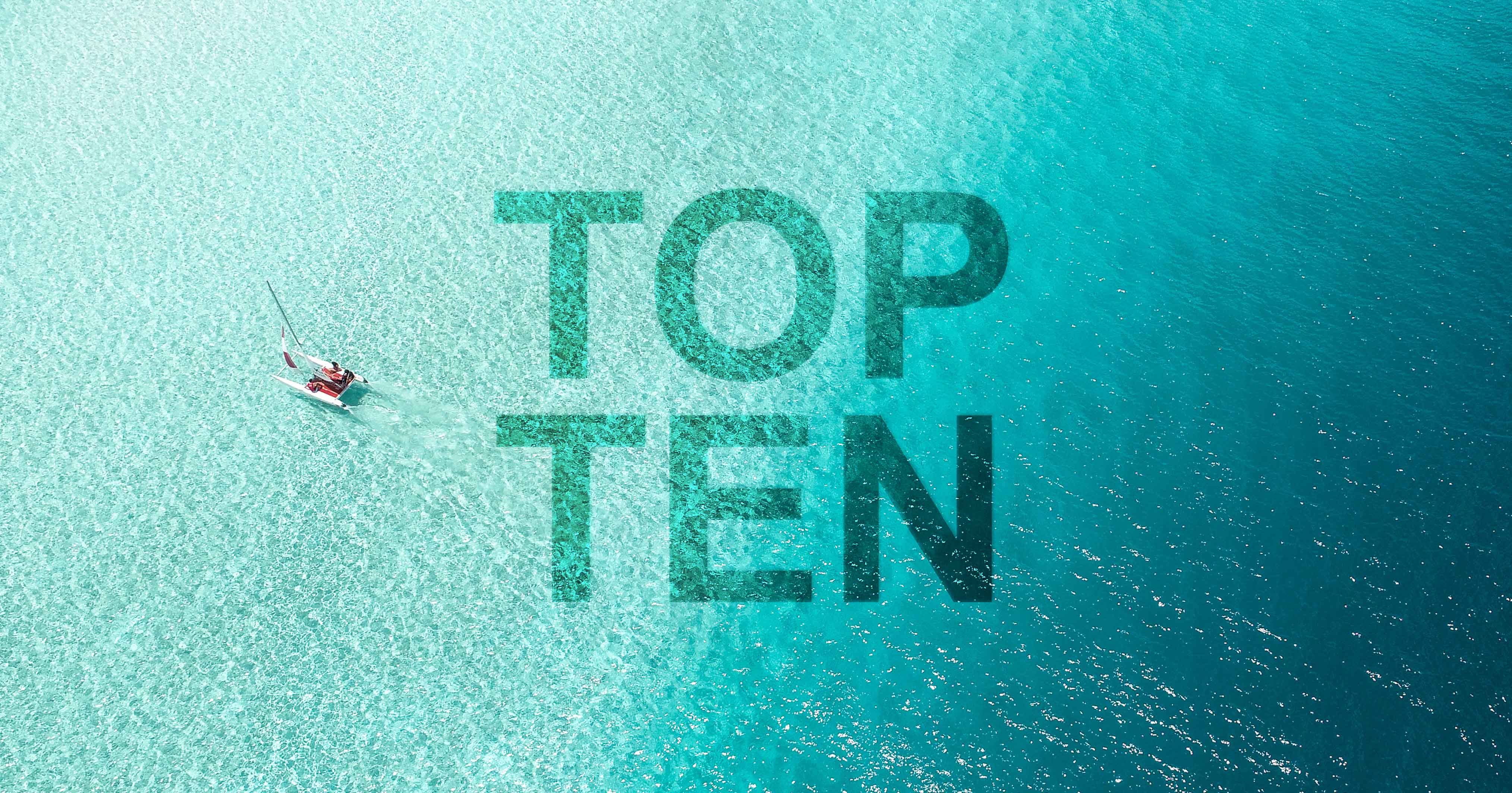 Text showing 'Top Ten' on a background of a tropical lagoon.